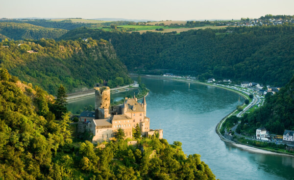 A river cruise ship gliding past European castles